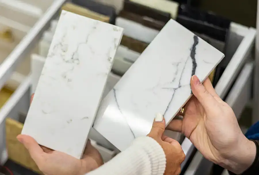 Cabinetland of Springfield - two people reviewing samples of countertop materials for new kitchen countertop remodel - Springfield, IL